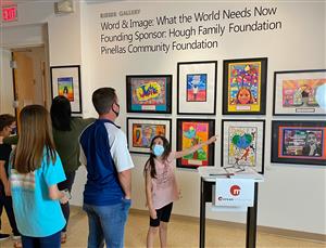 Student showing artwork at Word and Image exhibit 